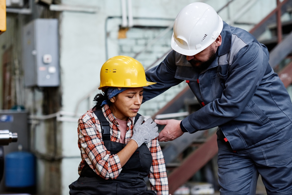 An Injured Worker getting help from another worker
